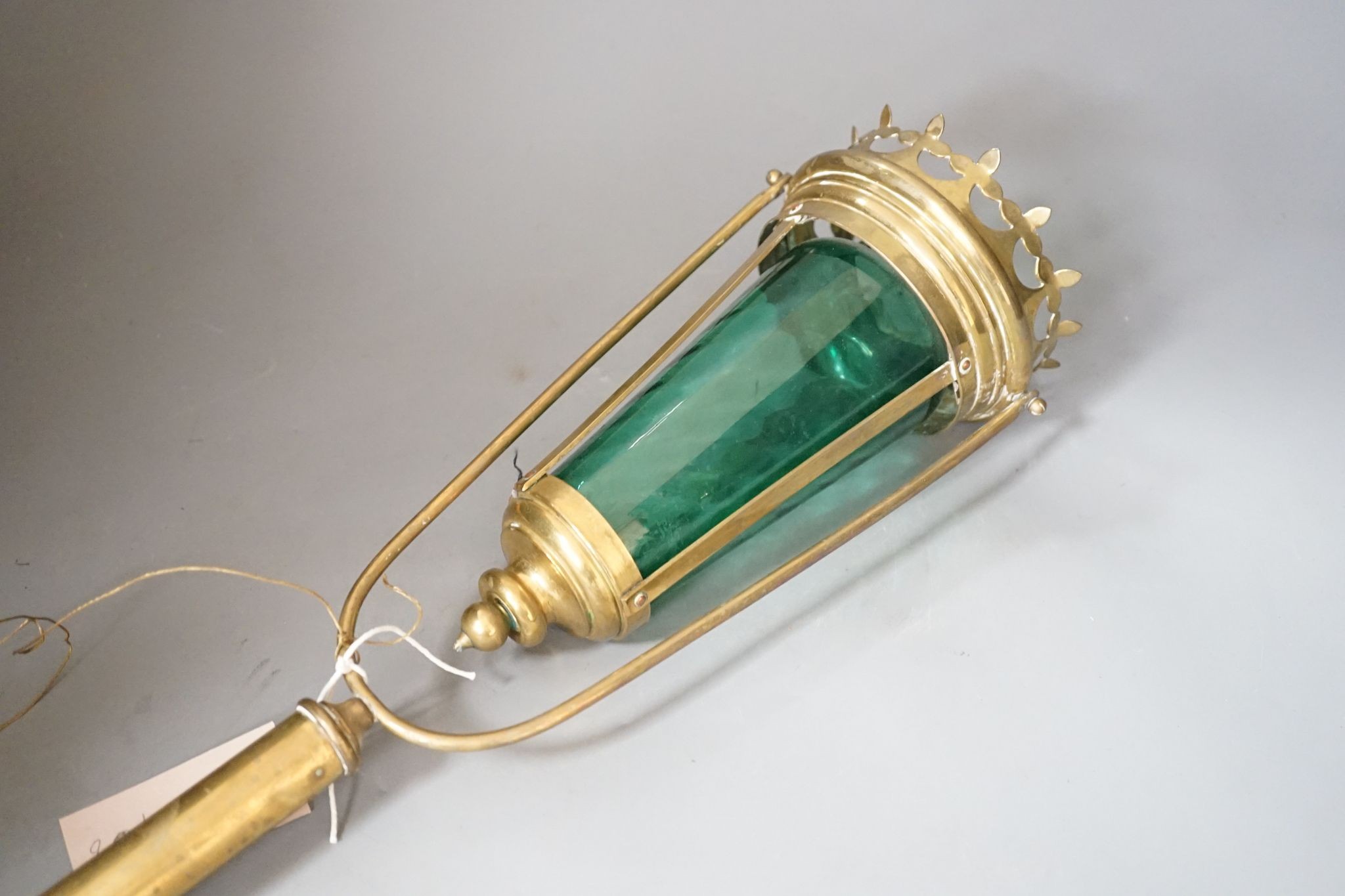 A brass and green glass processional lantern, with docking port, 90 cms high.